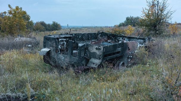 War in Ukraine, destroyed Russian armored car, military equipment, side view, Kharkiv region. - Photo, image