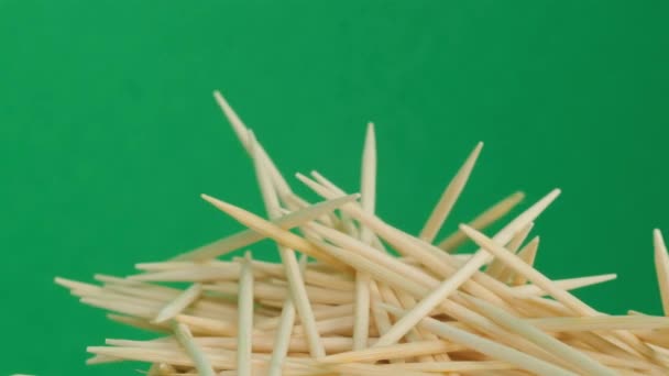 Close-up of a group of wooden toothpicks on a green chromakey background. 4k video - Záběry, video