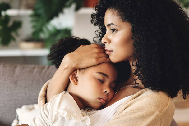 Family, mom with sleeping kid and love, peace and calm with relationship, care and relax at home. Content, black woman and tired girl with bond, comfort and hug with safe place, dream and sleep. - Photo, image