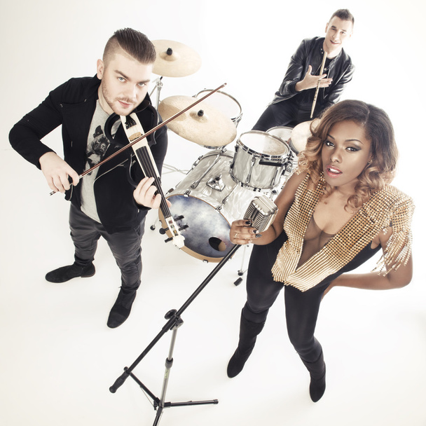 Fashionable music band posing. Two handsome man and beautiful sexy woman with music instruments - Photo, Image
