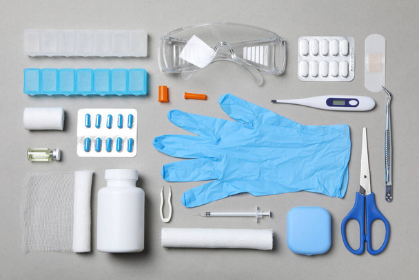 First aid kit supplies on gray background - Foto, Imagen