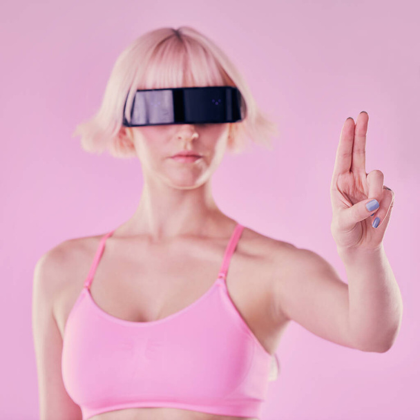 Metaverse, virtual reality glasses and a woman with hand for future scifi and ai 3d gaming technology. Model person on a pink background for cyberpunk and digital transformation for cyber world vr ux. - Foto, immagini