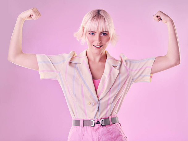 Woman, flexing arm muscle in portrait and smile, power and strong female isolated on pink background. Freedom fight, empowerment and strength with confidence, pride in challenge with champion and win. - Fotó, kép