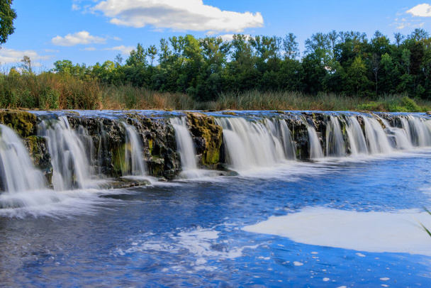Kuldiga. Ventas-Rumba waterfall.The widest waterfall in Europe (249 m), of natural nature, a number of legends and historical events are associated with the waterfall. - 写真・画像
