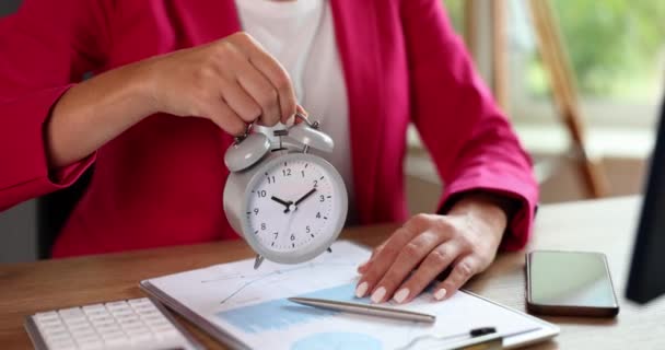 Business woman holding alarm clock in hand. Deadline and agenda time management concept. Manager boss pointing to the control of working time - Footage, Video
