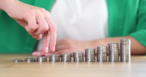 Businesswoman fingers go up bar chart from coins. Business growth and revenue growth - Video