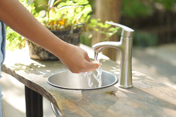 Female hands open water to wash hands - Fotoğraf, Görsel