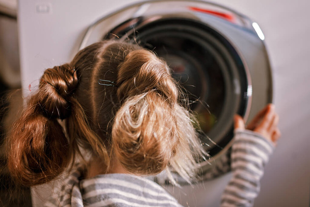 Eco-conscious teenage girl using common laundry to save resources and money. Sustainability and environment care. Conserving water, energy and natural resources. Eco-lifestyle in action - Foto, Imagen