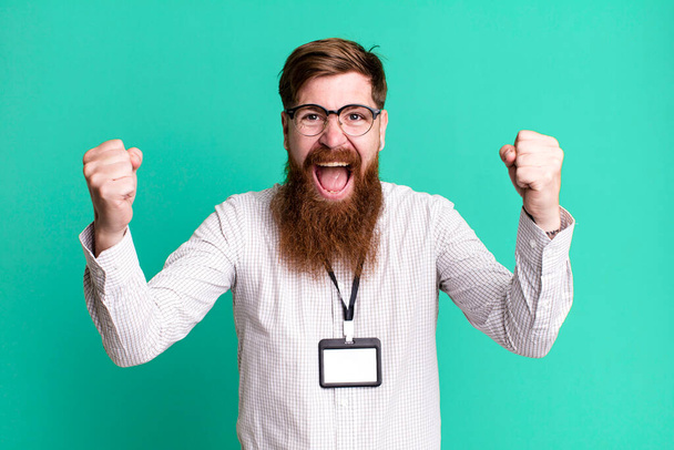 long beard man feeling shocked,laughing and celebrating success. vip badge accreditation concept - Photo, image