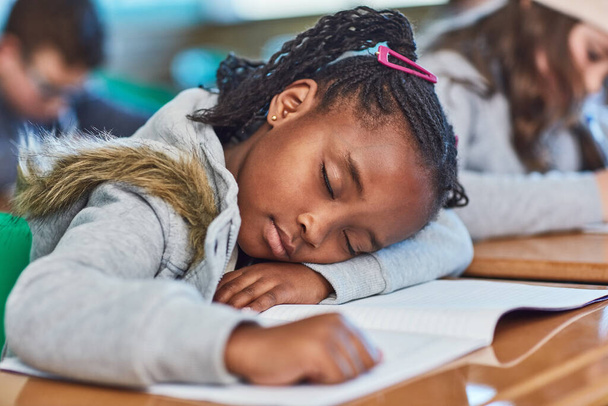 Sleeping beauty in class. an elementary school girl taking a nap in the classroom - Photo, Image