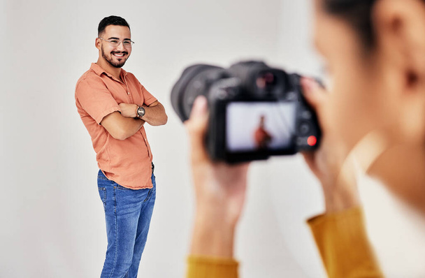 Shooting, photography and photographer with man model in studio for creative, advertising and image. Media, backstage and professional woman videographer with guy, camera and equipment for photoshoot. - Fotoğraf, Görsel