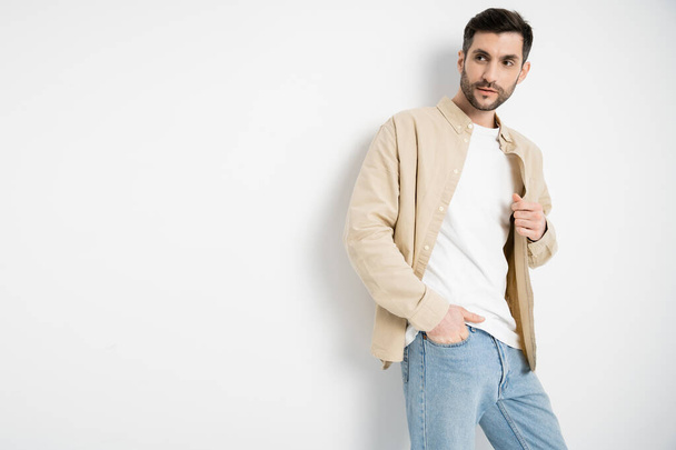 Man in casual clothes and jeans posing on white background  - Fotoğraf, Görsel