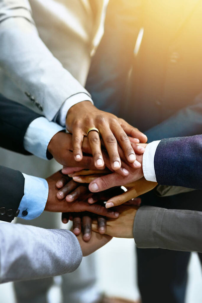 Strong business starts with a strong team. a group of businesspeople joining their hands in solidarity - Foto, imagen