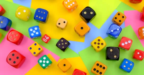 colourful dices on a rotating table with multicolored paper sticky notes on background - Video, Çekim