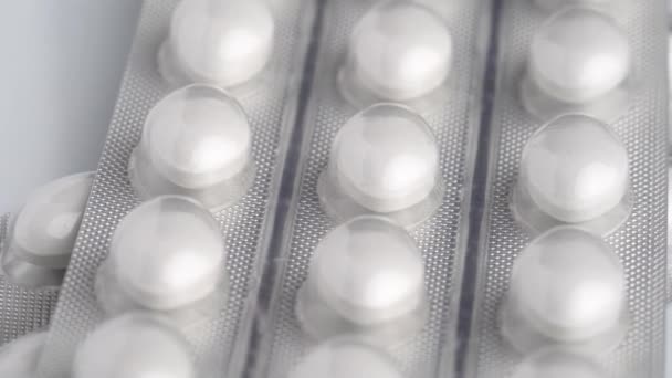 White tablets in blister rotate on white background, macro close-up.  - Filmmaterial, Video