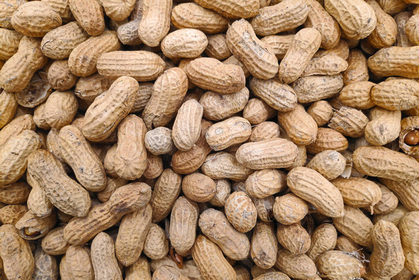 Close-up on a stack of peanuts for sale on a market stall. - Fotó, kép
