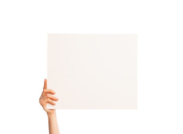 one hand holding a big white piece of cardboard. - Photo, Image