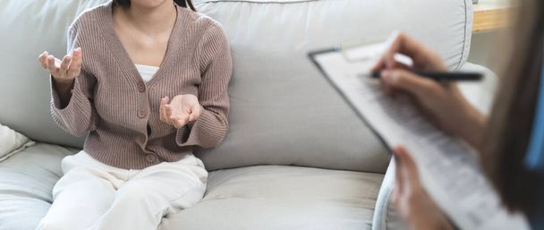Jeune femme en thérapie mentale discutant avec un psychologue au bureau. - Photo, image