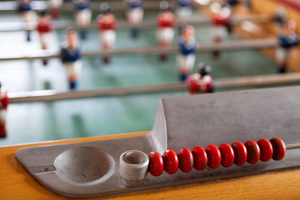 Table football, commonly called fuzboll or foosball and sometimes table soccer, is a table-top game that is loosely based on association football. - Photo, image