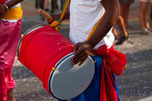 Musician playing with a dholak during the carnival of Grand Boucan. - Foto, afbeelding