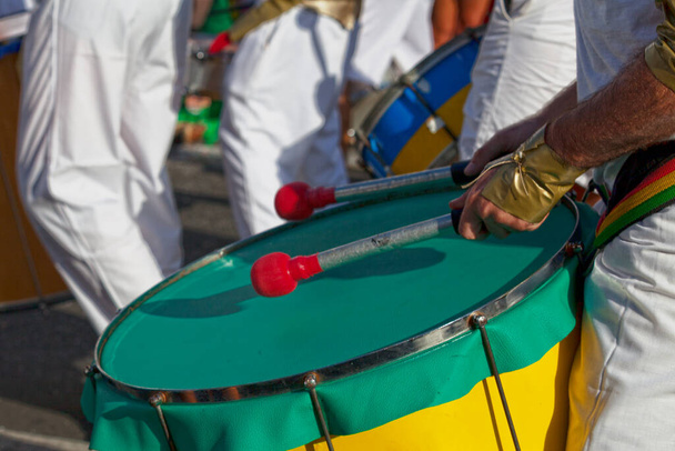 Close-up on a percussionist playing with a drum during the carnival of the Grand Boucan. - 写真・画像