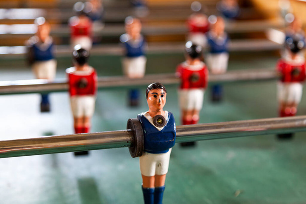 Table football, commonly called fuzboll or foosball and sometimes table soccer, is a table-top game that is loosely based on association football. - Photo, Image