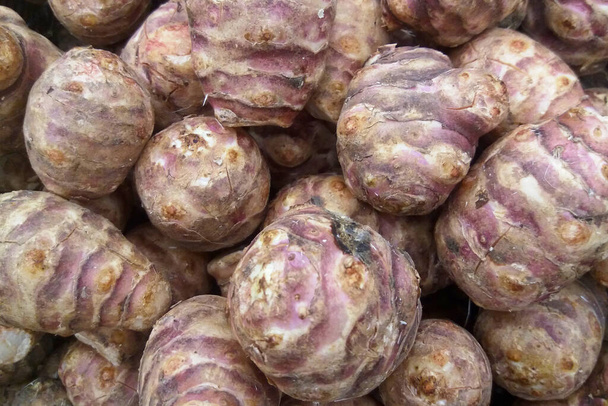 Close-up on a stack of Jerusalem artichokes for sale on a market stall. - 写真・画像