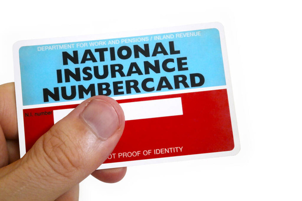 Fingers of a man holding a National Insurance Number Card - Foto, immagini