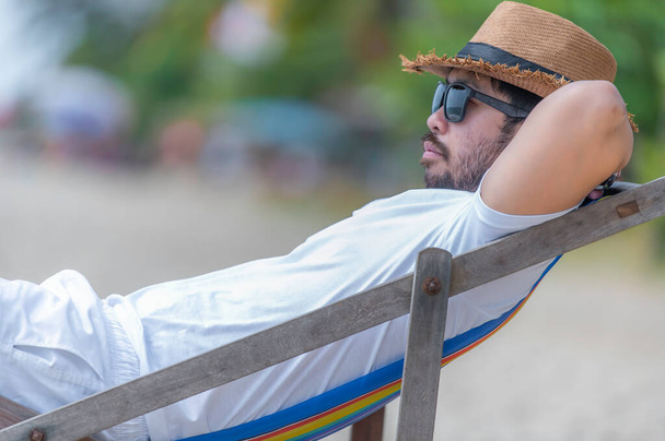 Asian man sitting chair beach inside sea,Relax time at summer - Valokuva, kuva