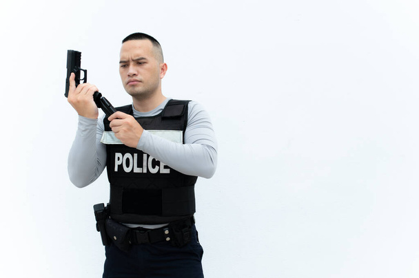 Portrait of police hold gun in hand on white background,Handsome asian cop - Photo, image