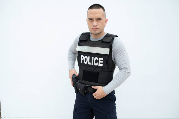 Portrait of police hold gun in hand on white background,Handsome asian cop - Zdjęcie, obraz