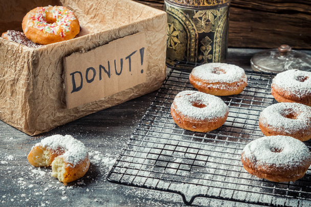 Tasting sweet donuts with icing sugar - Foto, Bild
