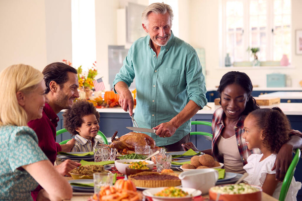 Grandfather Serving As Multi-Generation Family Celebrating Thanksgiving At Home Eating Meal Together - Photo, image