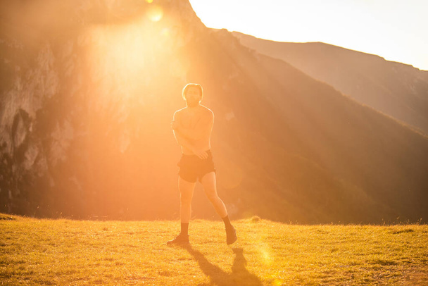 Man boxing with shadow exercising at sunset outdoor. Port victory healthy lifestyle concept. Man shadow boxing little champion boxer silhouette sun. - Photo, Image