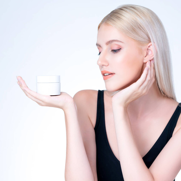 Closeup personable beautiful perfect natural cosmetic makeup skin woman holding mockup jar moisturizer cream for healthy skincare treatment, anti-aging product advertisement in isolated background. - 写真・画像