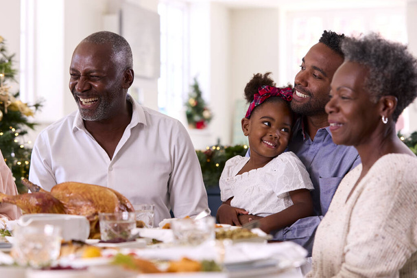Multi-Generation Family Celebrating Christmas At Home With Grandfather Serving Turkey - Zdjęcie, obraz