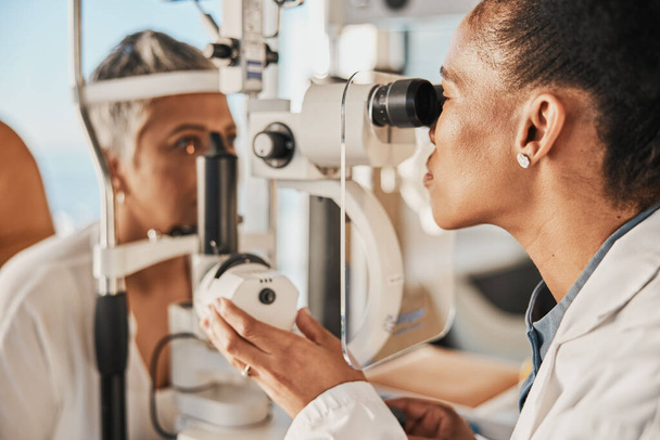 Optometry, ophthalmology and eye exam by optometrist with a patient senior woman with medical insurance using slit lamp. Doctor, eyesight and healthcare professional doing vision test in clinic. - Photo, Image