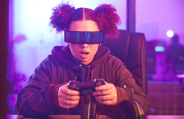 Night, virtual reality and gaming girl with joystick, innovation and vr metaverse in neon lighting. Female gamer, cyberspace tech and glasses for 3D experience, digital AR fantasy and gen z esports. - Foto, Imagen