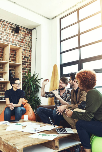 Be clear about what you want to grow. a group of young designers having a discussion in a modern office - Zdjęcie, obraz