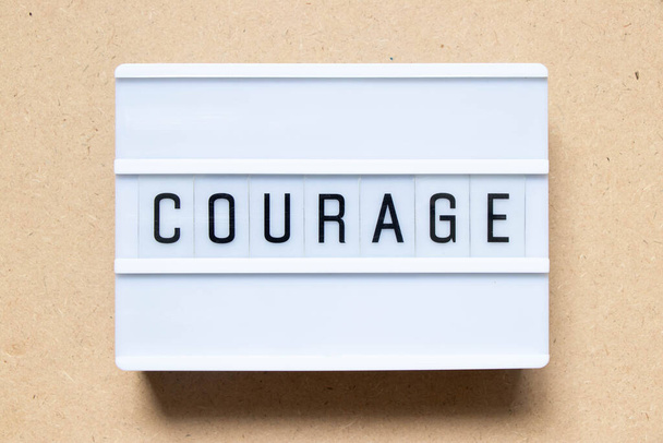 Lightbox with word courage on wood background - Photo, Image