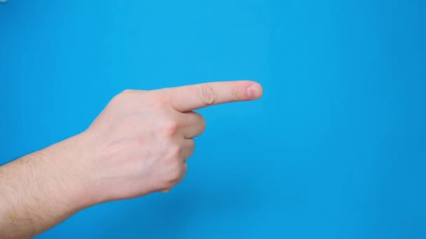 Close-up of European mans hand showing index finger to side, gesture isolated on blue screen screen background. - Video, Çekim