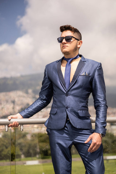 attractive male model wears a formal suit, tie and sunglasses, young man with short hair, lifestyle and fashion, nature park background - 写真・画像