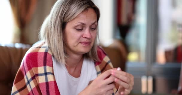 Nasal spray in hand of sick weak beautiful woman sitting on couch at home. . Symptoms and treatment of allergic infectious rhinitis - Záběry, video