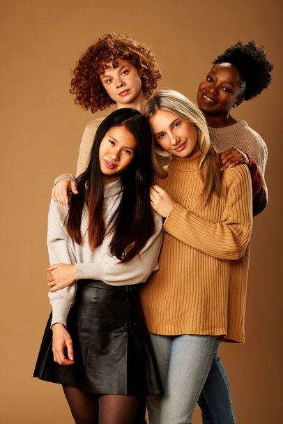 Multicultural girls with no makeup posing isolated on brown background. - Valokuva, kuva