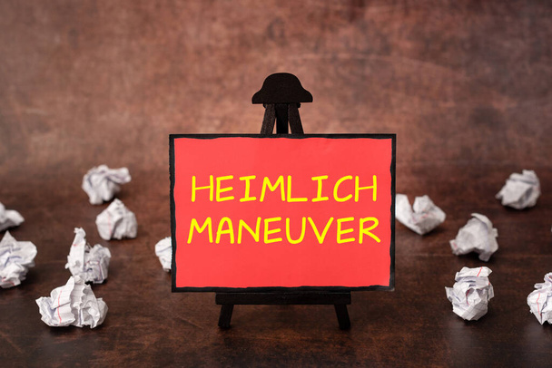 Tekst met inspiratie Heimlich Maneuver, Concept betekent toepassing van opwaartse druk in geval van verstikking - Foto, afbeelding