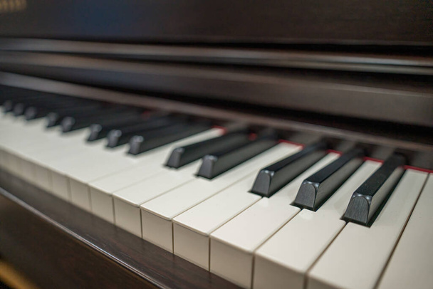 Piano keyboard background with selective focus. Warm color toned image. Classic grand piano keyboard close-up - Photo, Image