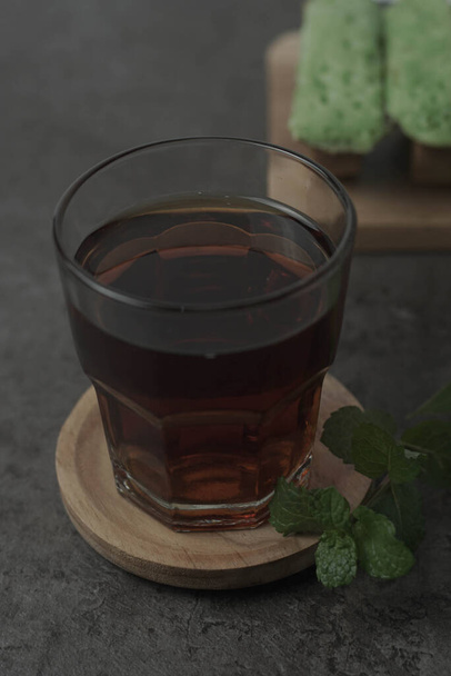 Savourez une tasse de thé chaude avec des Kue Pukis fraîchement préparés - une collation traditionnelle indonésienne. Parfait pour une matinée confortable ou pour vous donner de l'énergie! - Photo, image