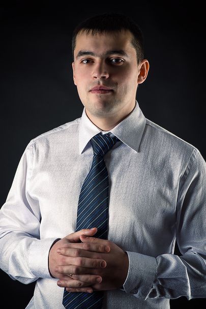 Portrait young businessman isolated on black background - Foto, Imagen