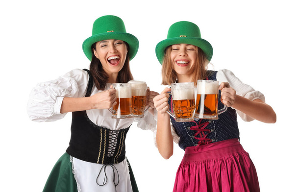 Irish waitresses with glasses of beer on white background. St. Patrick's Day celebration - Foto, Bild