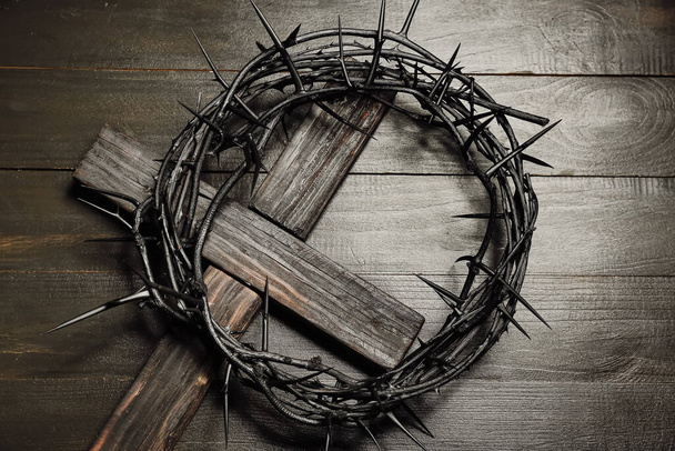 Crown of thorns with cross on dark wooden background - Photo, Image